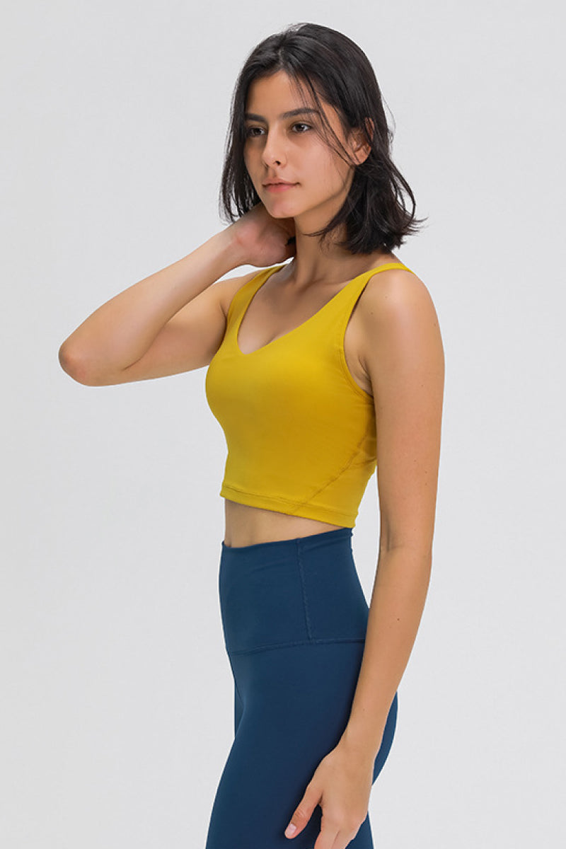 Mustard yellow scoop-back sports bra with wide straps and cropped hem