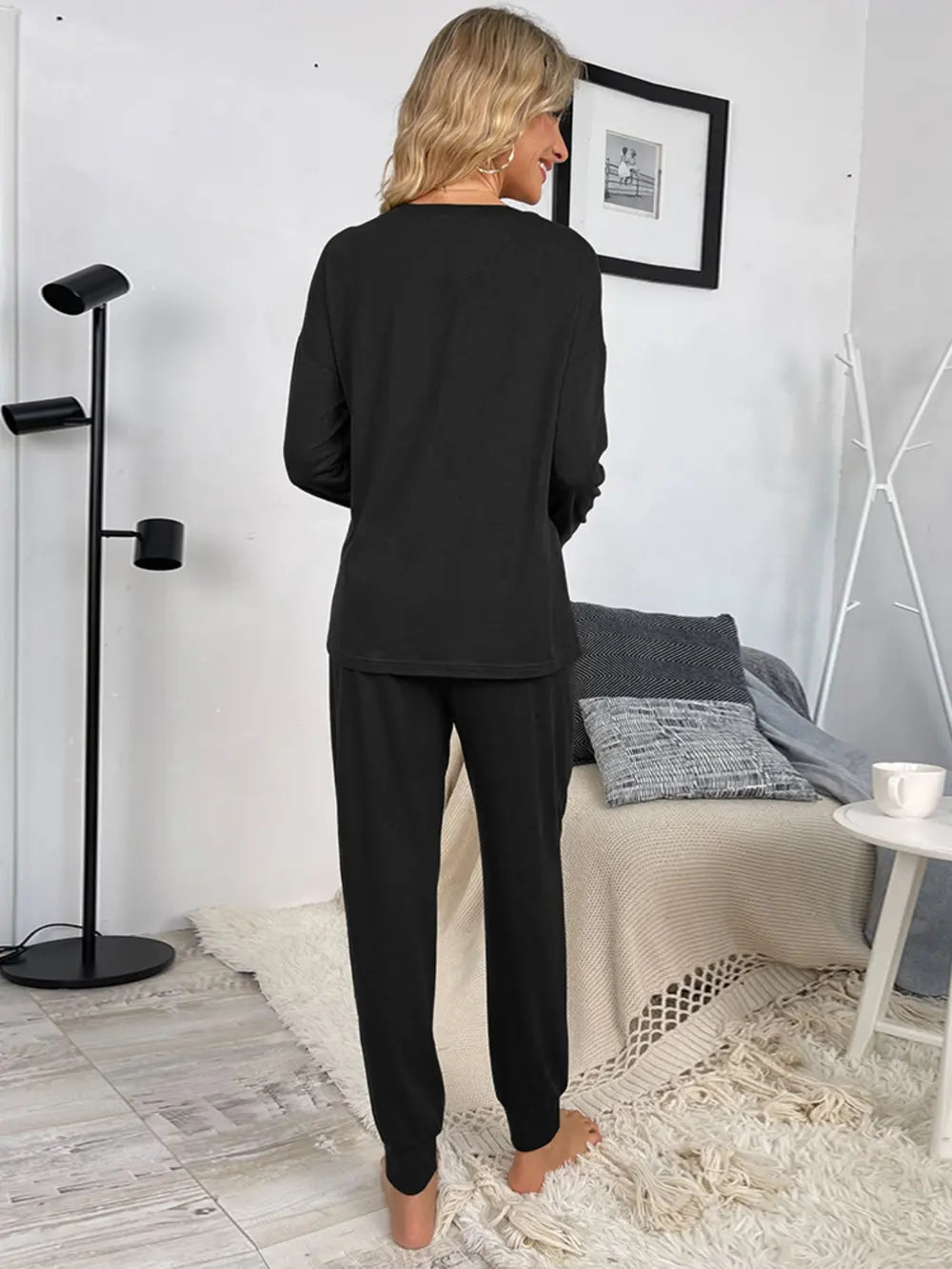 Black long-sleeve lounge top and drawstring jogger pants, back view