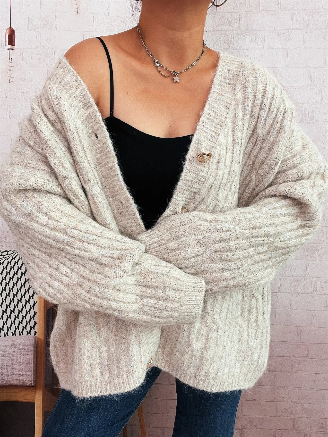 Cream cable knit button-up cardigan with V-neck and button front, relaxed fit