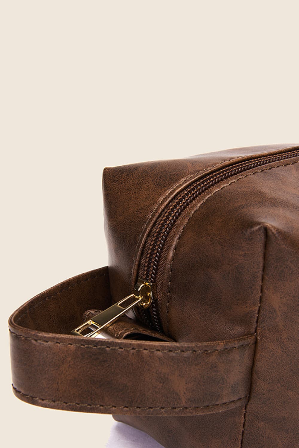 Vegan leather makeup bag in dark brown, open top with gold zipper and clasp