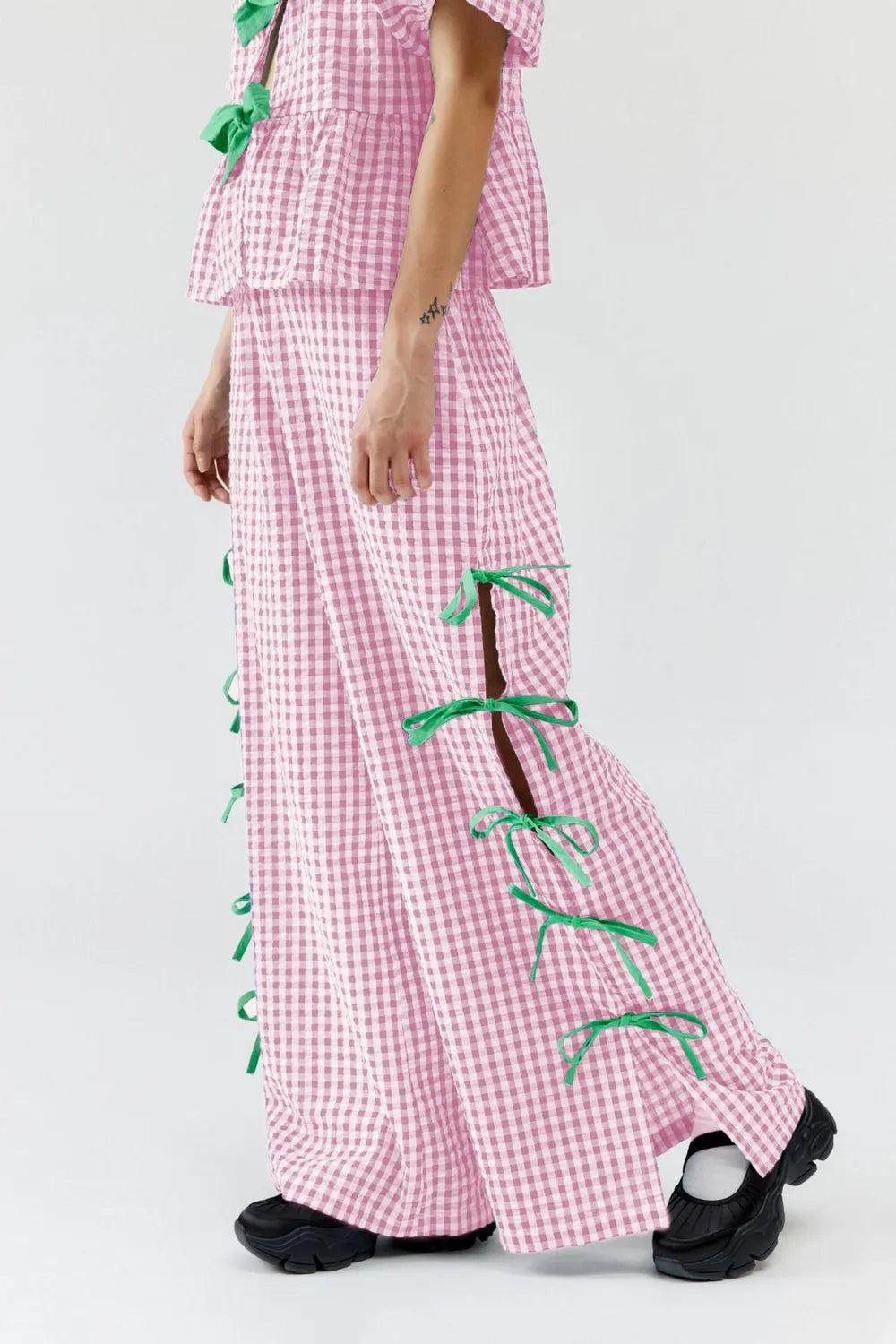 Pink gingham plaid wide-leg pants with side ties and tiered ruffle trim