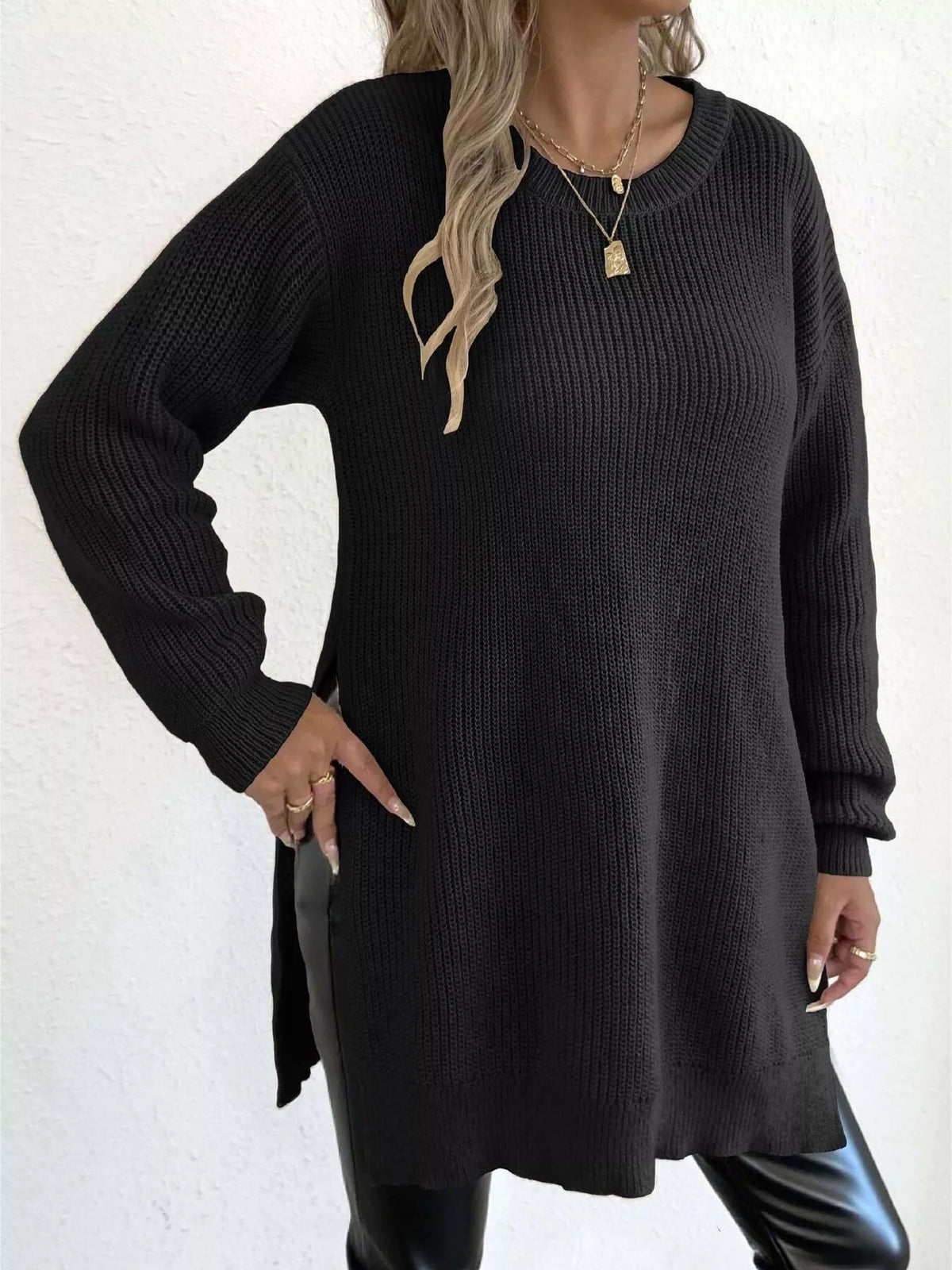Black ribbed knit drop-shoulder sweater tunic with crew neck, long sleeves, side slit