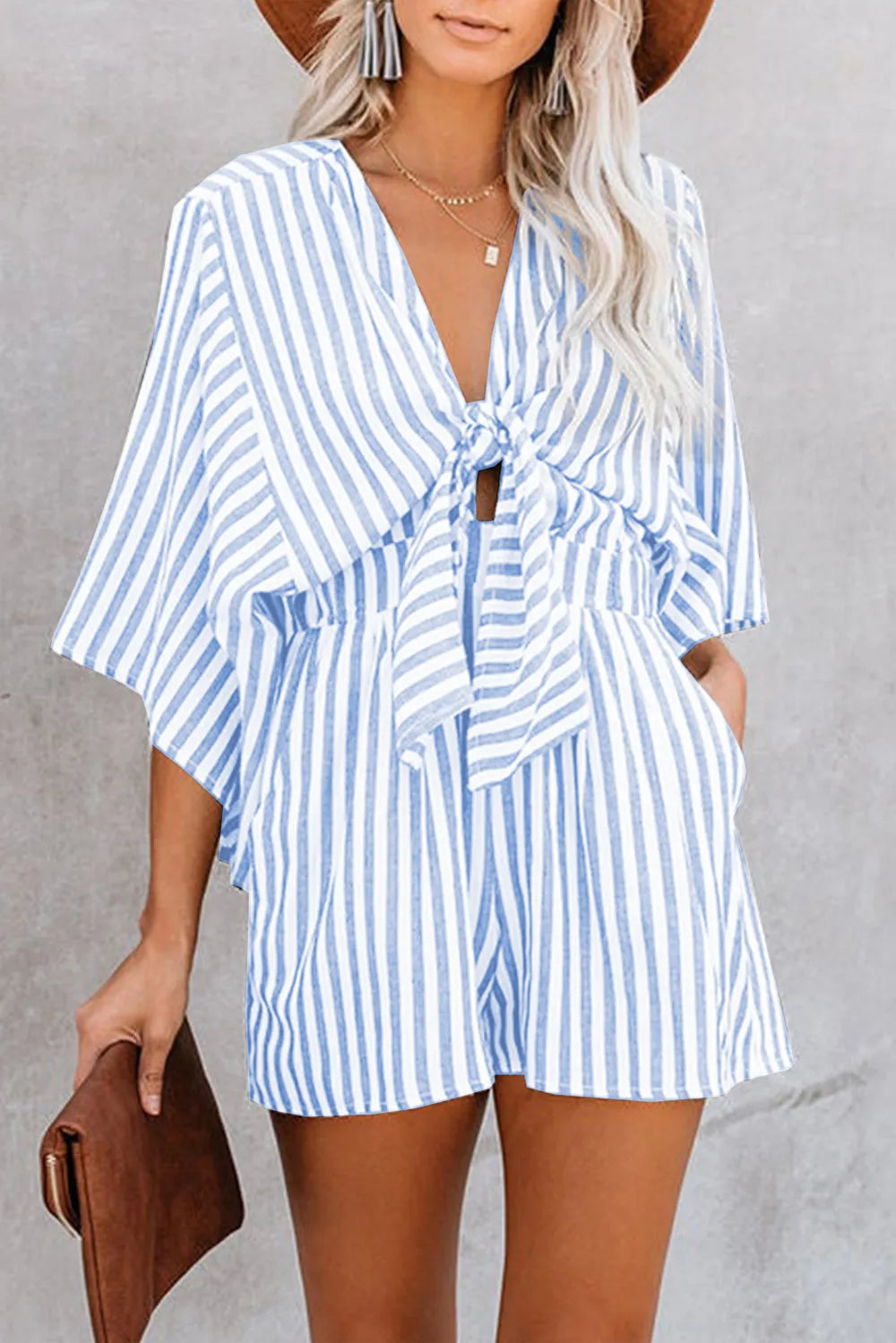 Blue striped kimono sleeve romper with V-neck and bow-tie waist detail