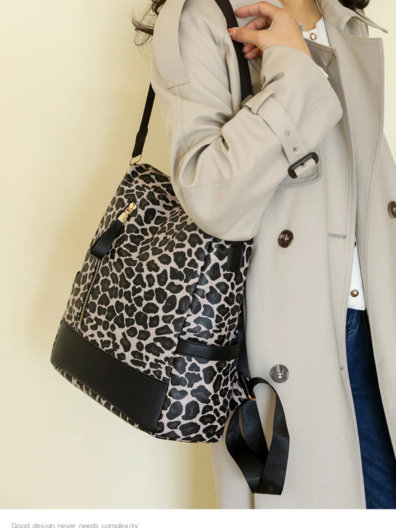 Leopard print backpack with black base, shoulder straps, and gold-tone zipper pulls.
