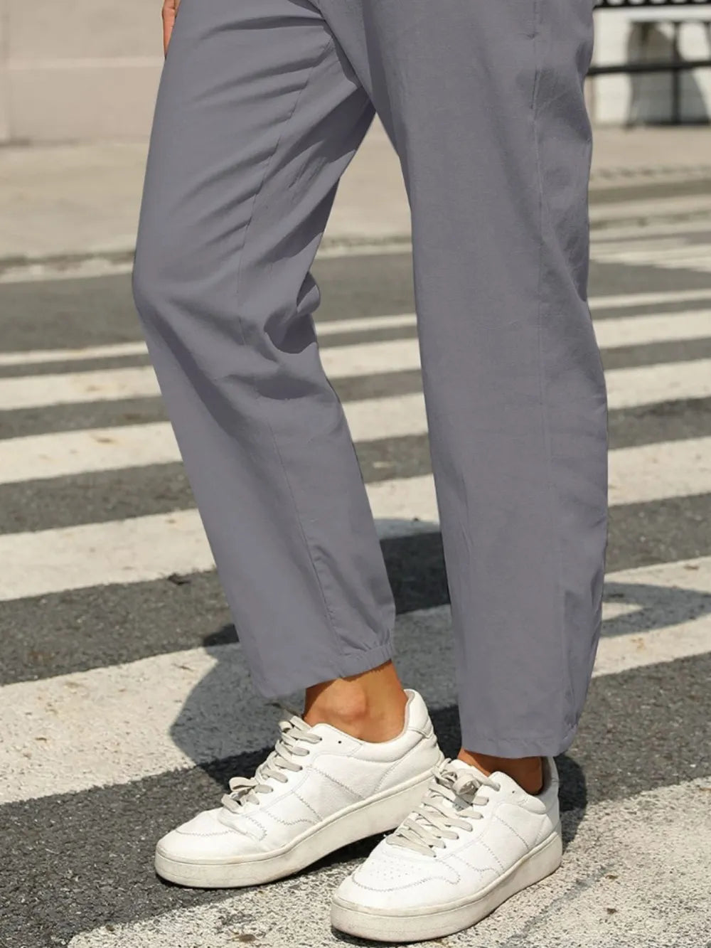 Gray tapered elastic-waist pants with cuffed ankle hem