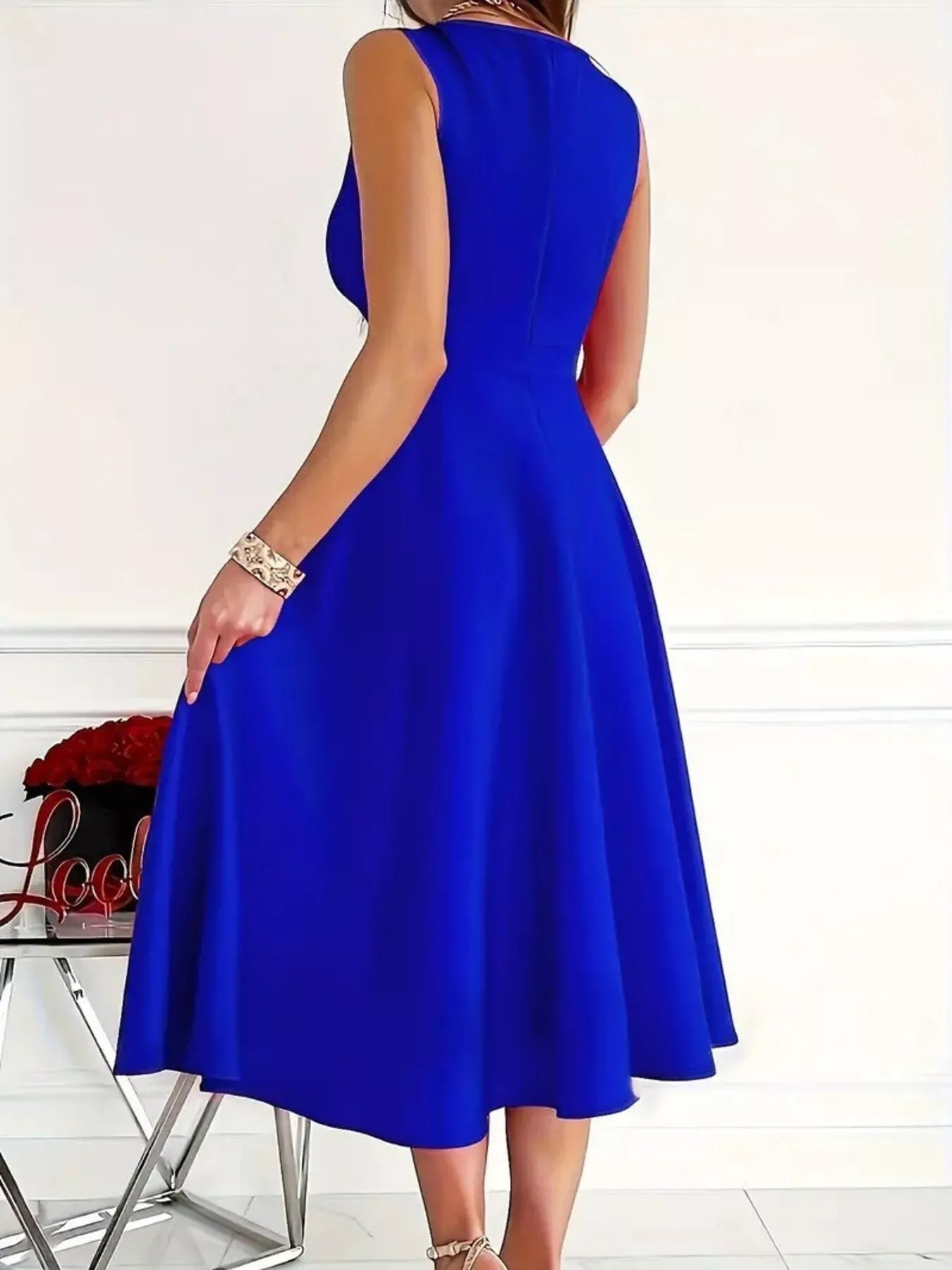 Blue sleeveless A-line midi dress from back, flared skirt