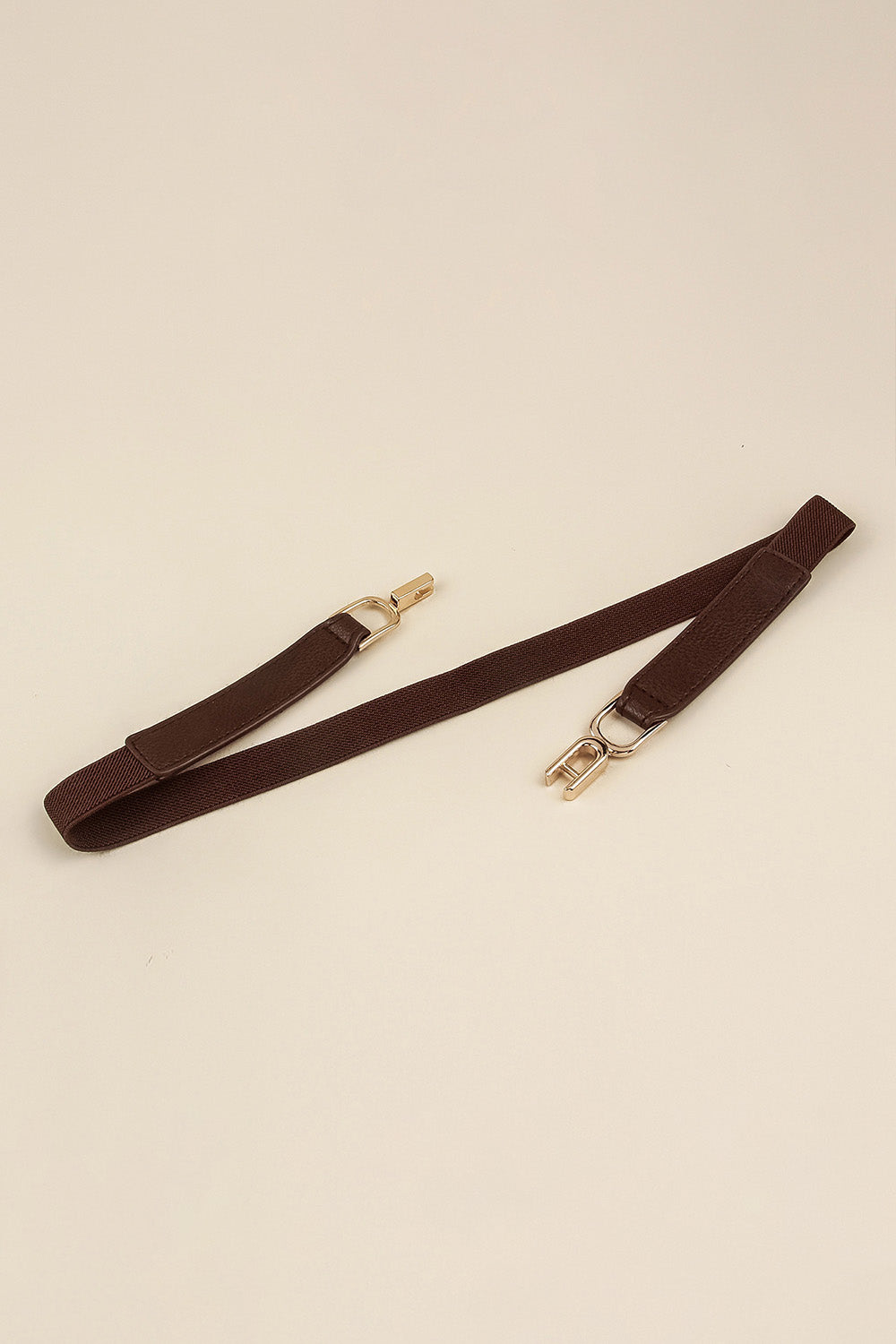 Elastic belt with dark brown strap and gold-tone buckle hardware