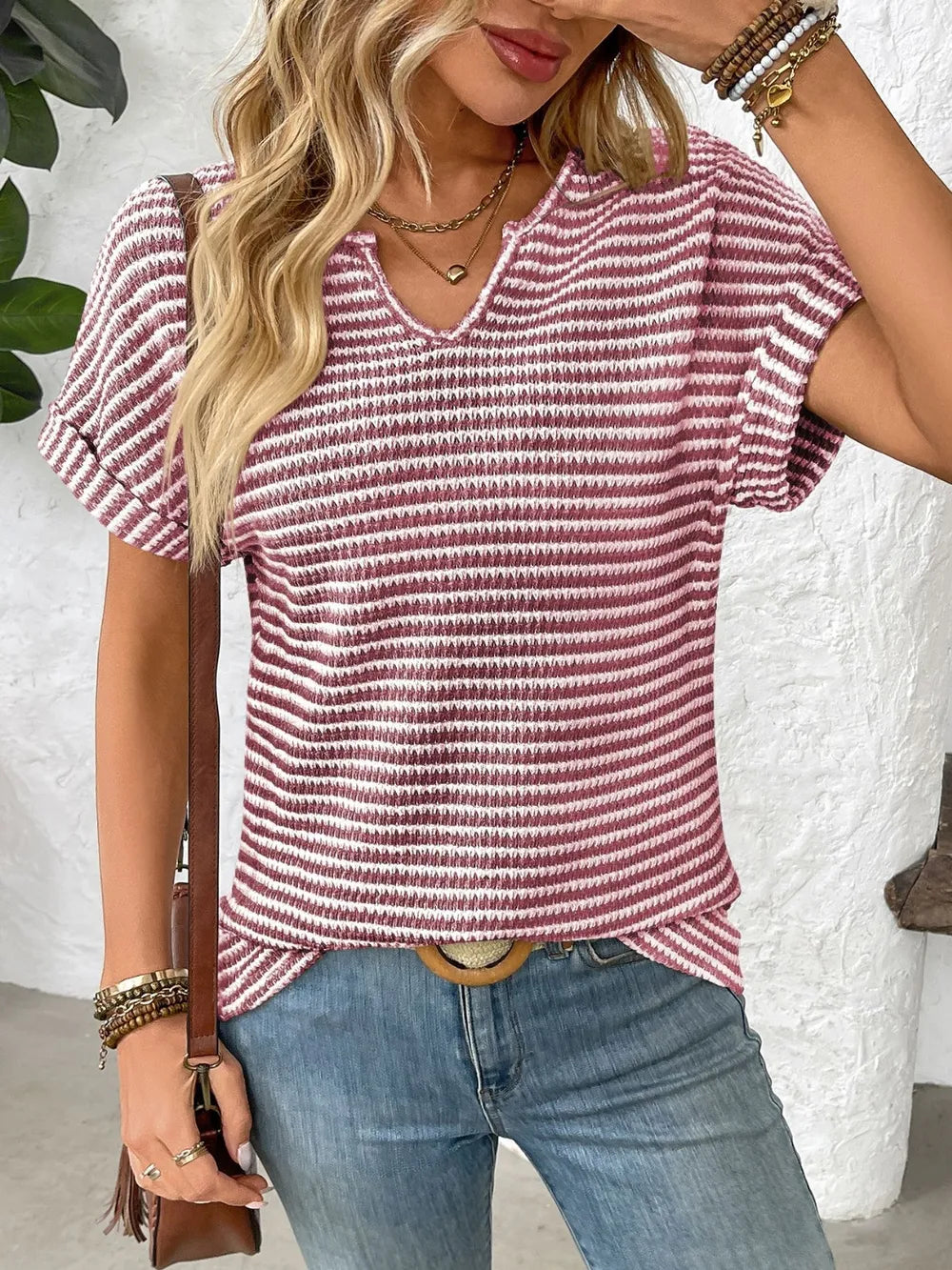 Red and white striped short-sleeve V-neck t-shirt, ribbed texture and casual drape