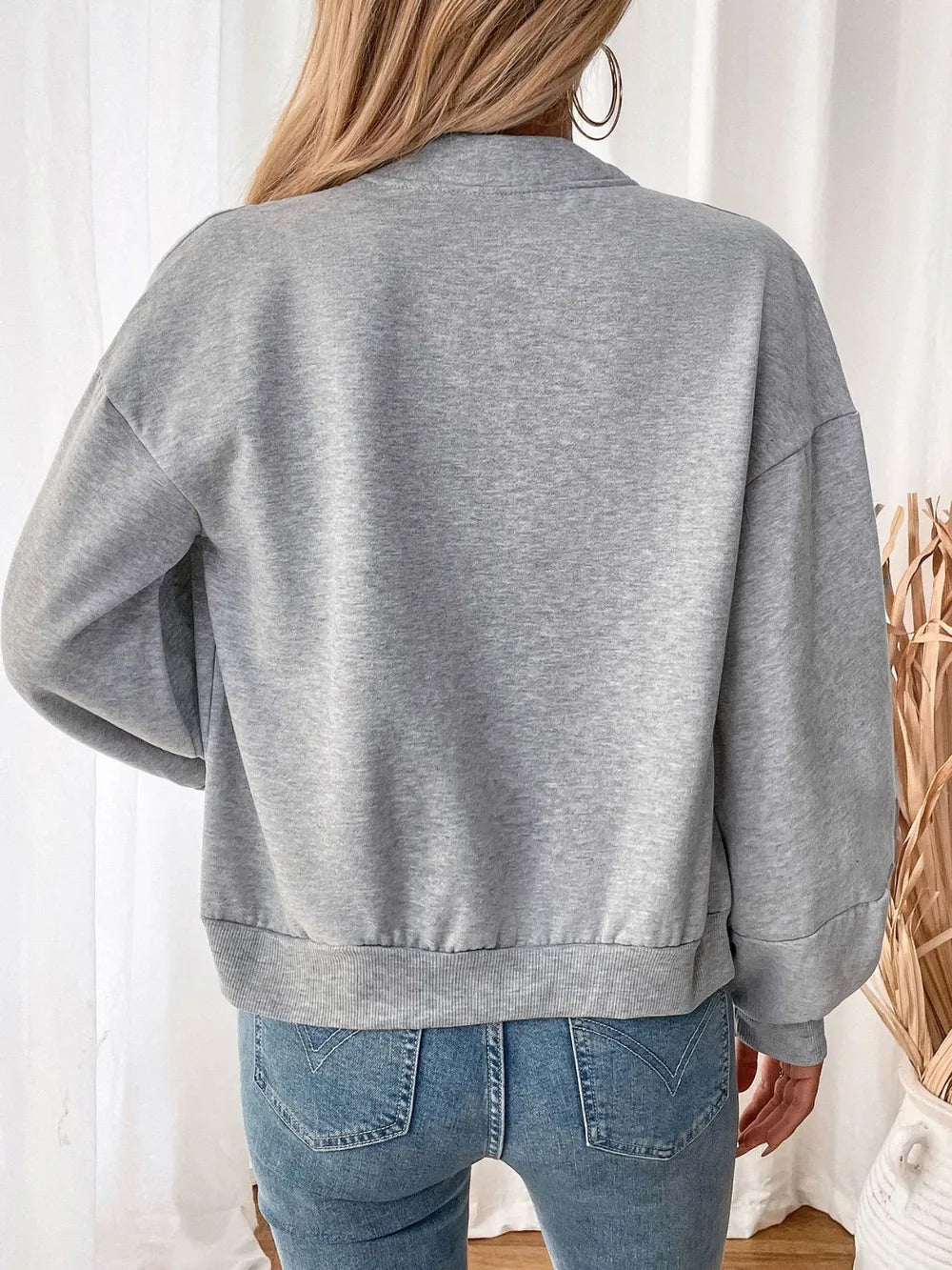 Light gray zip-up long sleeve sweatshirt, back view with ribbed hem and cuffs