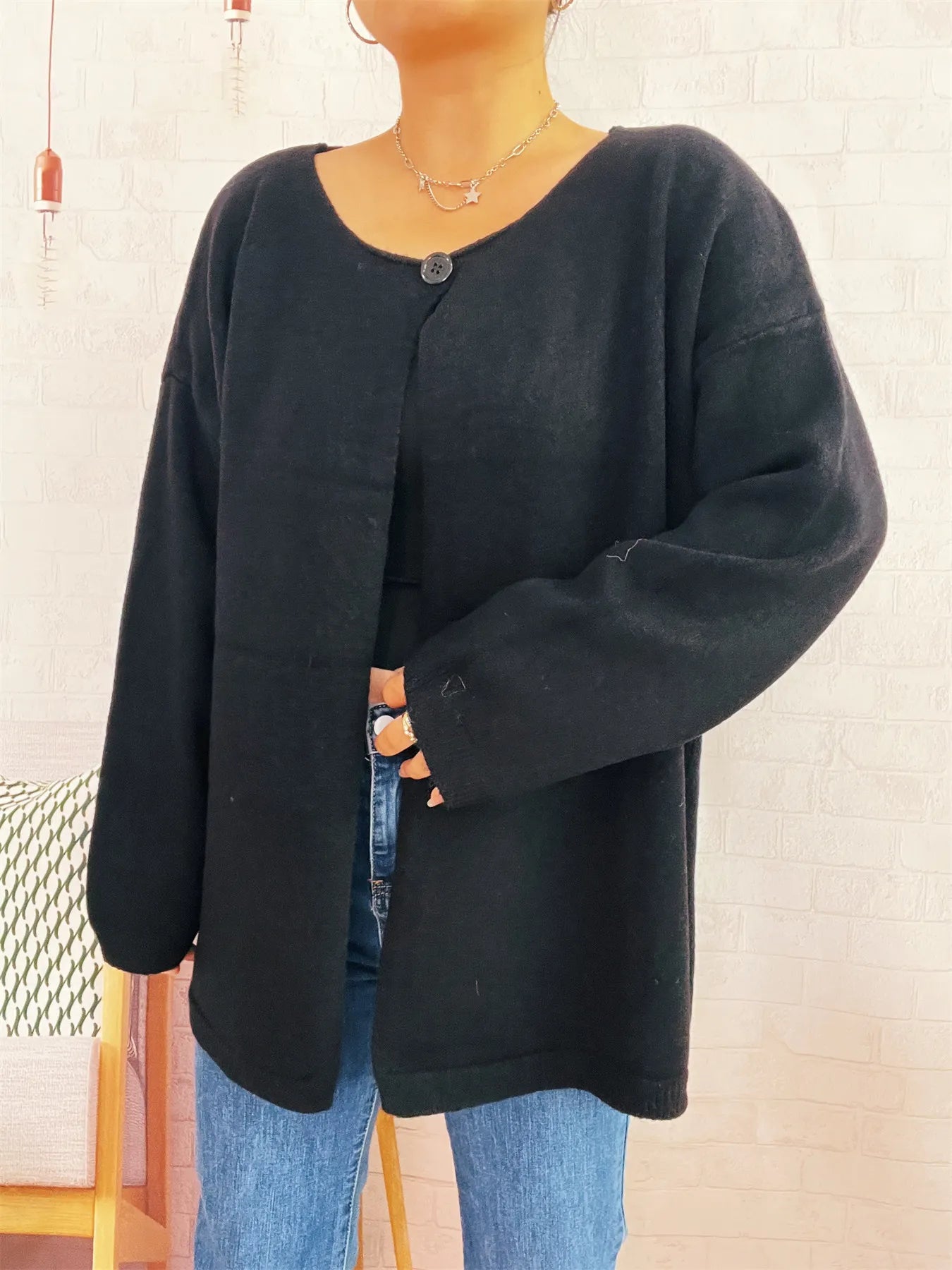 Black one-button drop-shoulder cardigan with crew neck and long sleeves