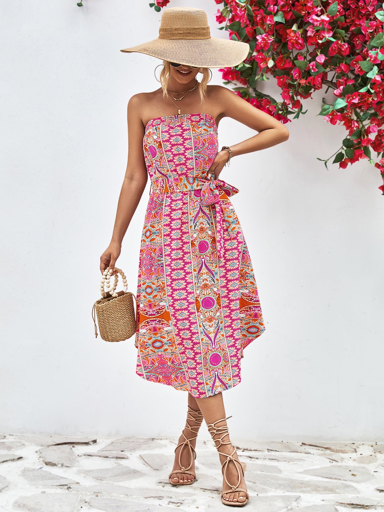 Hot pink strapless tie-belt dress with vibrant geometric print, gathered waist, midi