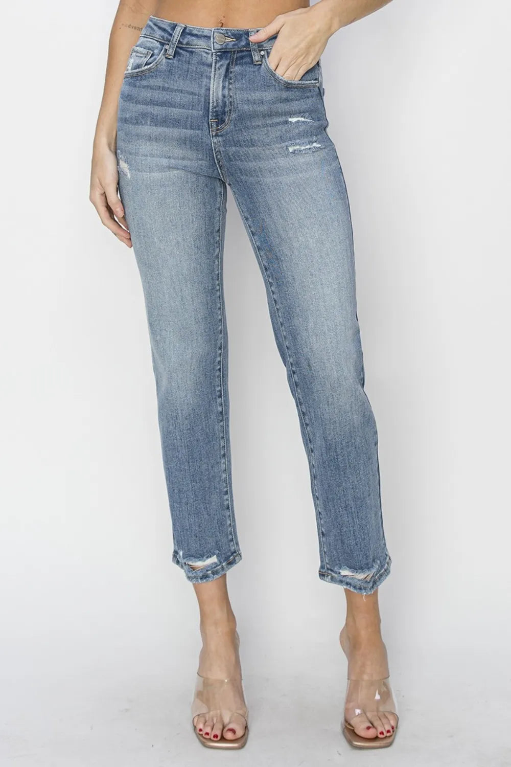 High-waist medium-wash cropped jeans with subtle fading and frayed ankle hems.