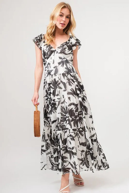 Cream and black floral print tiered maxi dress with ruffled cap sleeves and V-neck