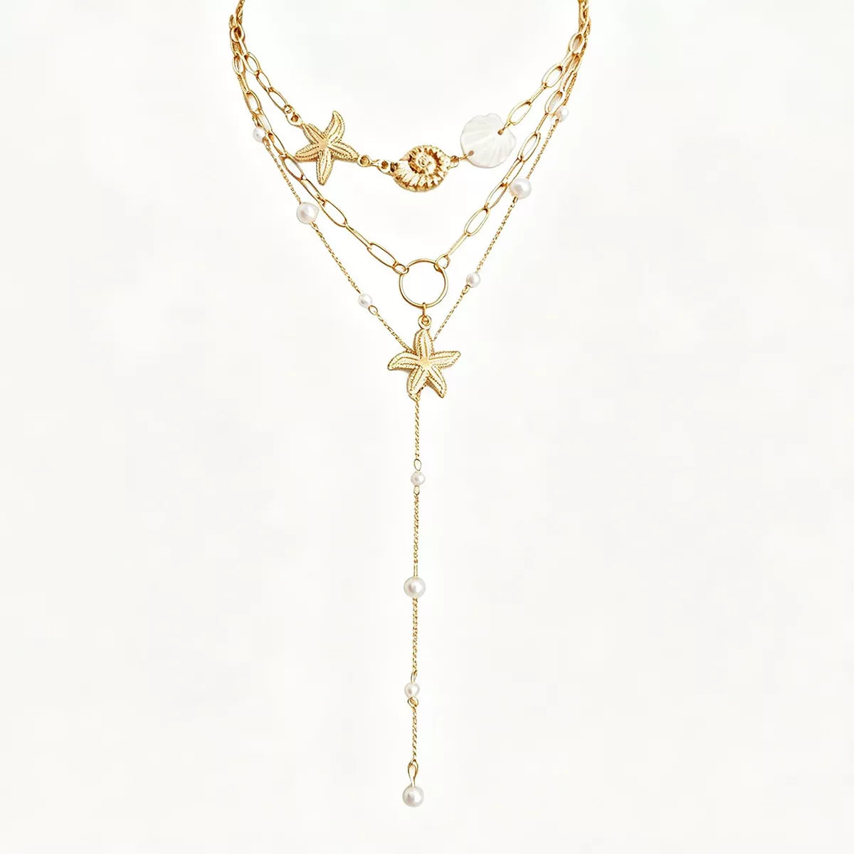 Gold layered starfish and seashell necklace with long pearl dangle