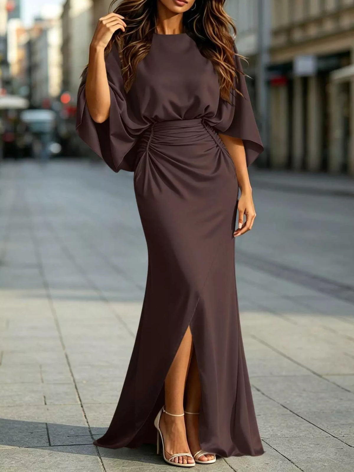 Maxi dress with ruched waist, draped dolman sleeves, and front slit in dark plum