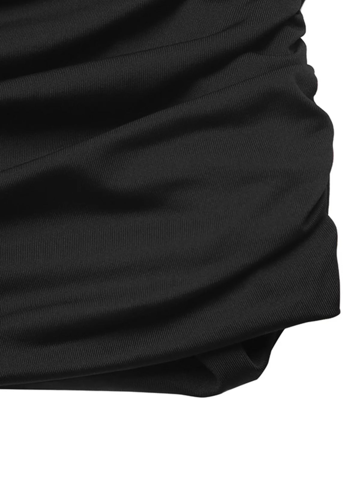 Close-up of ruched black fabric on fitted mini skirt