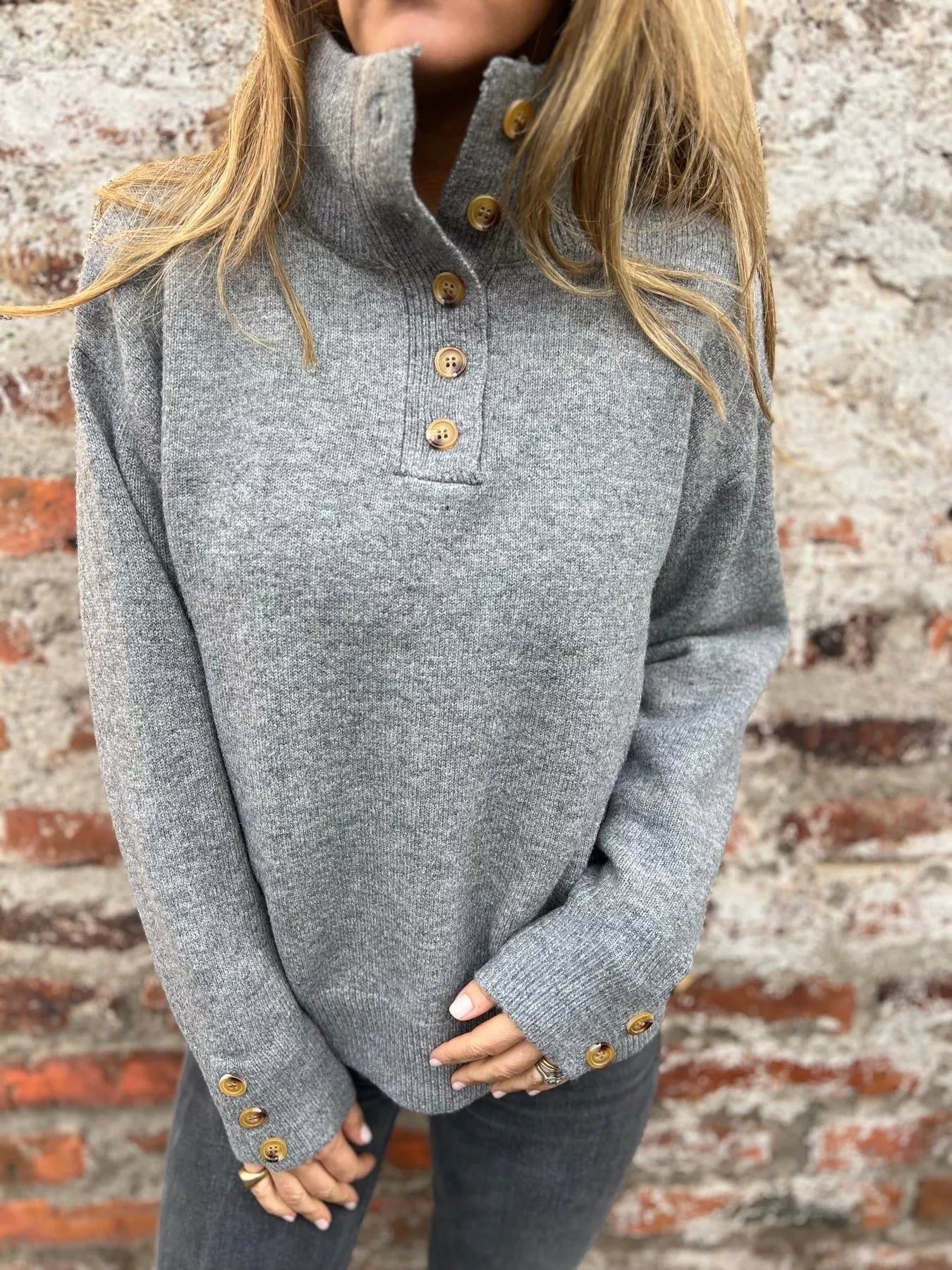 Grey turtleneck sweater with button placket and long sleeves, gold-tone cuff buttons