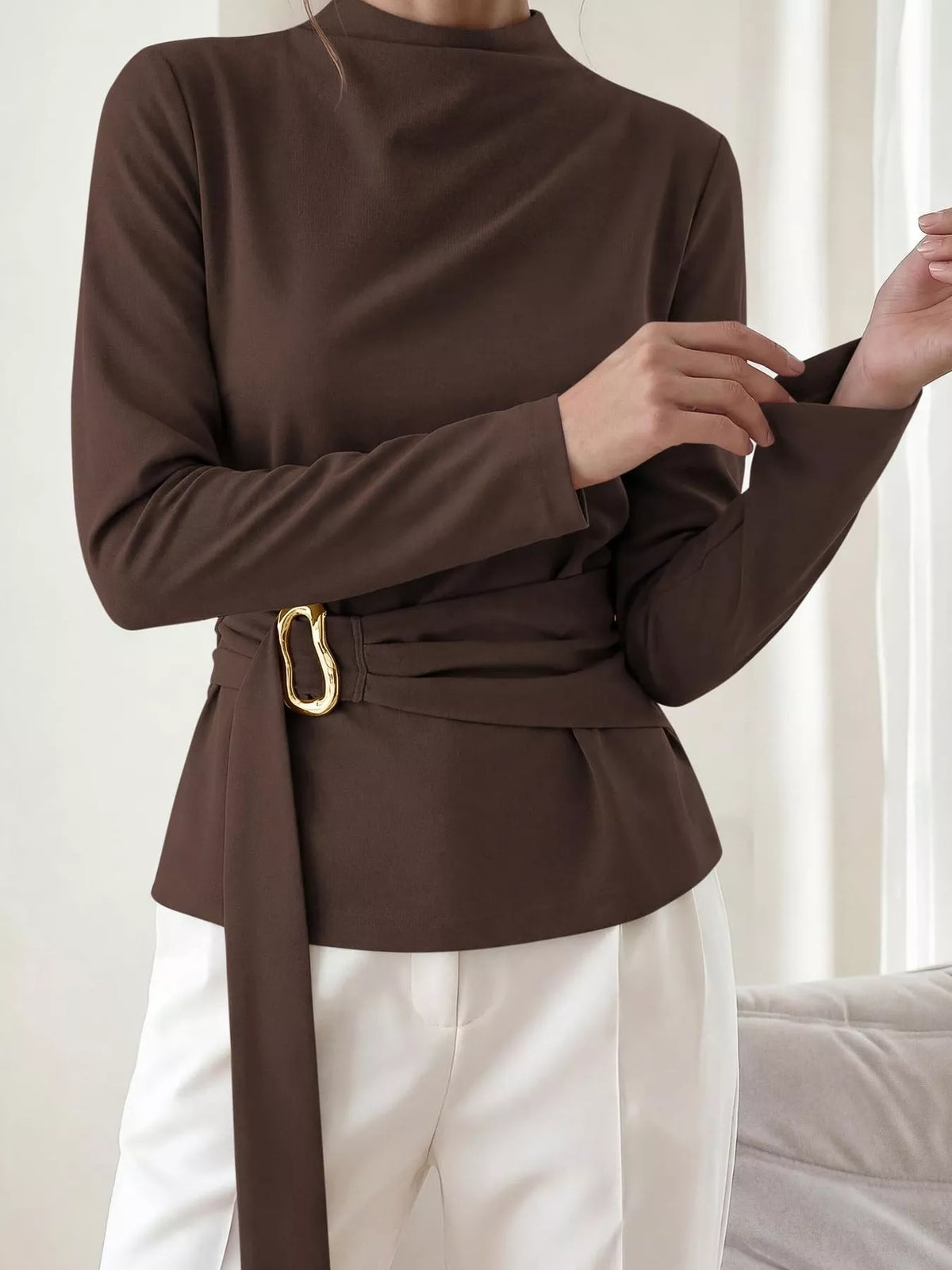 Brown mock neck blouse with long sleeves, ruched waist detail and gold ring buckle