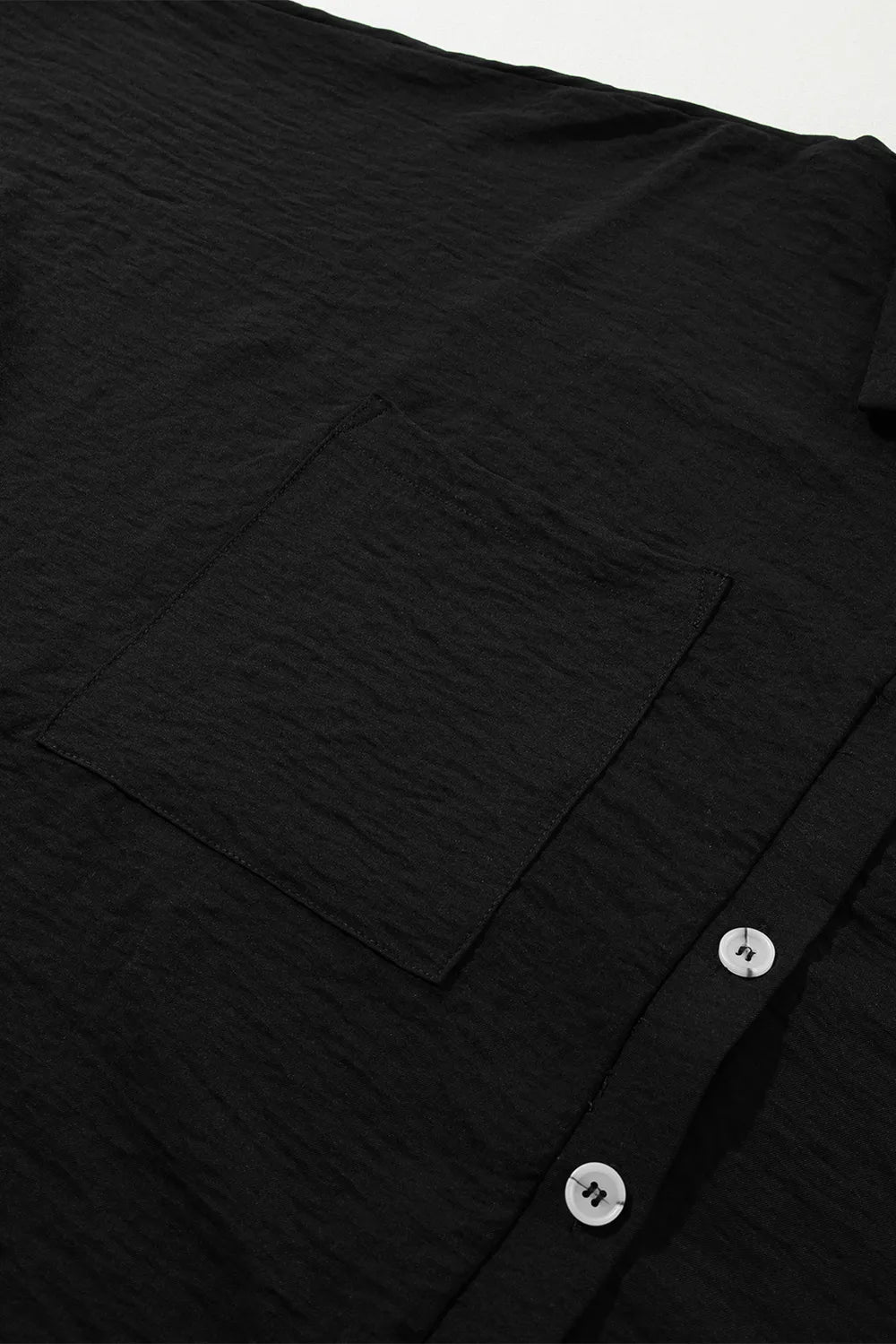 Black romper front panel with short sleeves and button placket