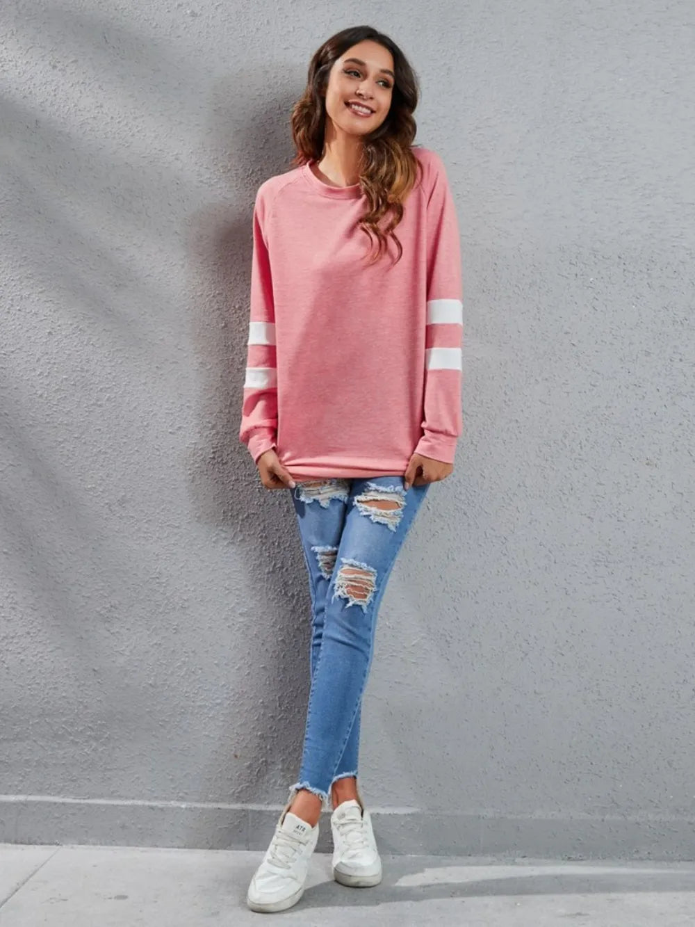 Pink long-sleeve t-shirt with round neck and white striped sleeves