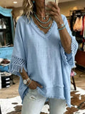Light blue loose V-neck blouse with fringe trim and crochet lace sleeves