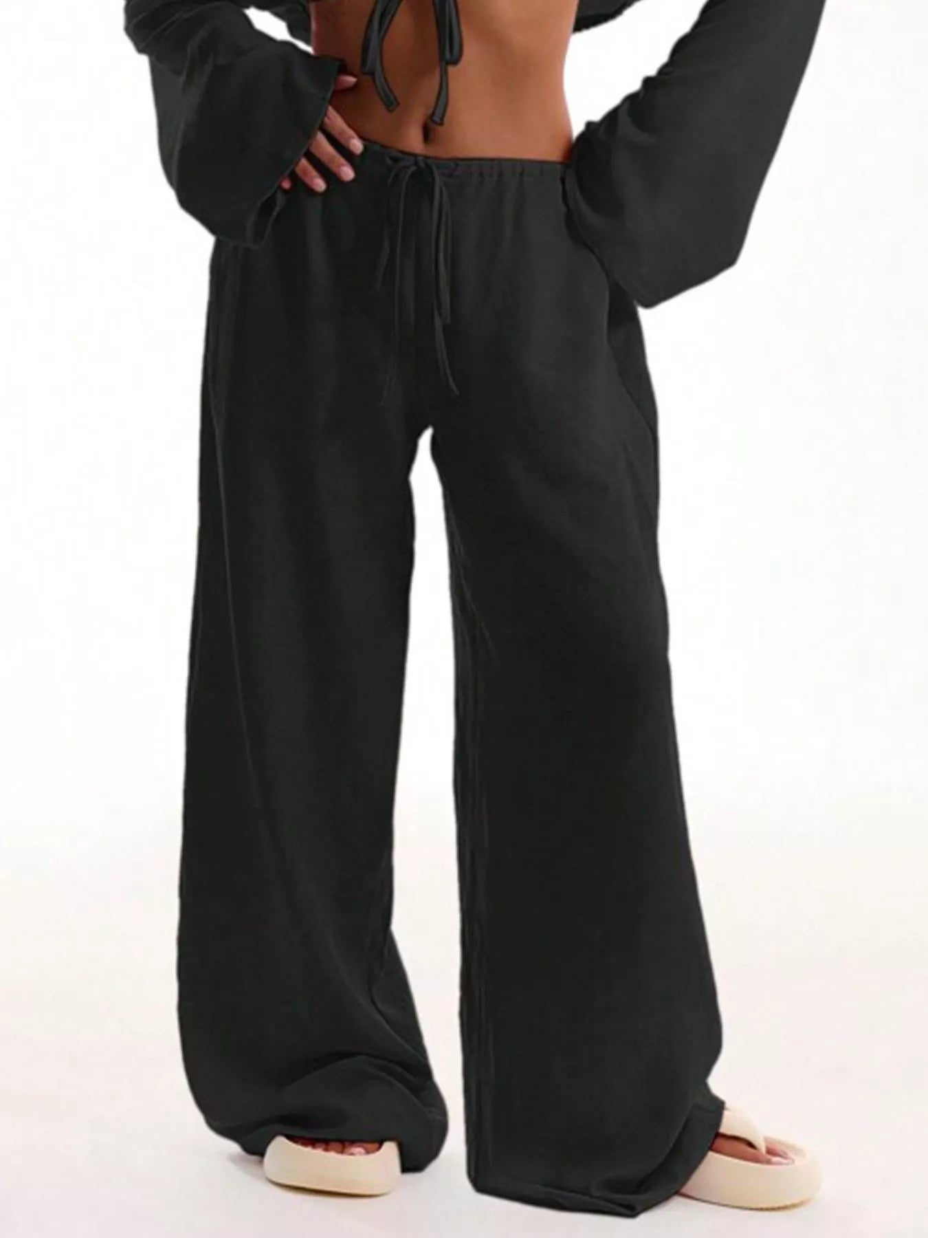 Black drawstring wide-leg pants with side pockets and roomy straight legs
