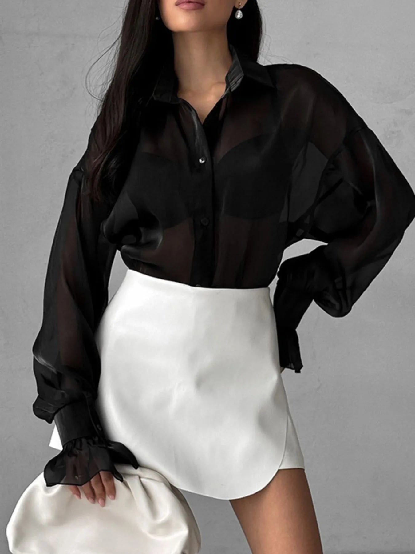 Sheer black button-up shirt with voluminous flounce sleeves and button front