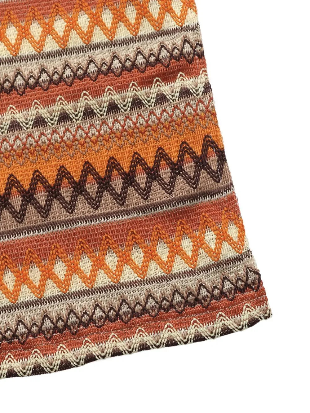 Striped dress hem with zigzag pattern and caramel, cream, and dark brown tones