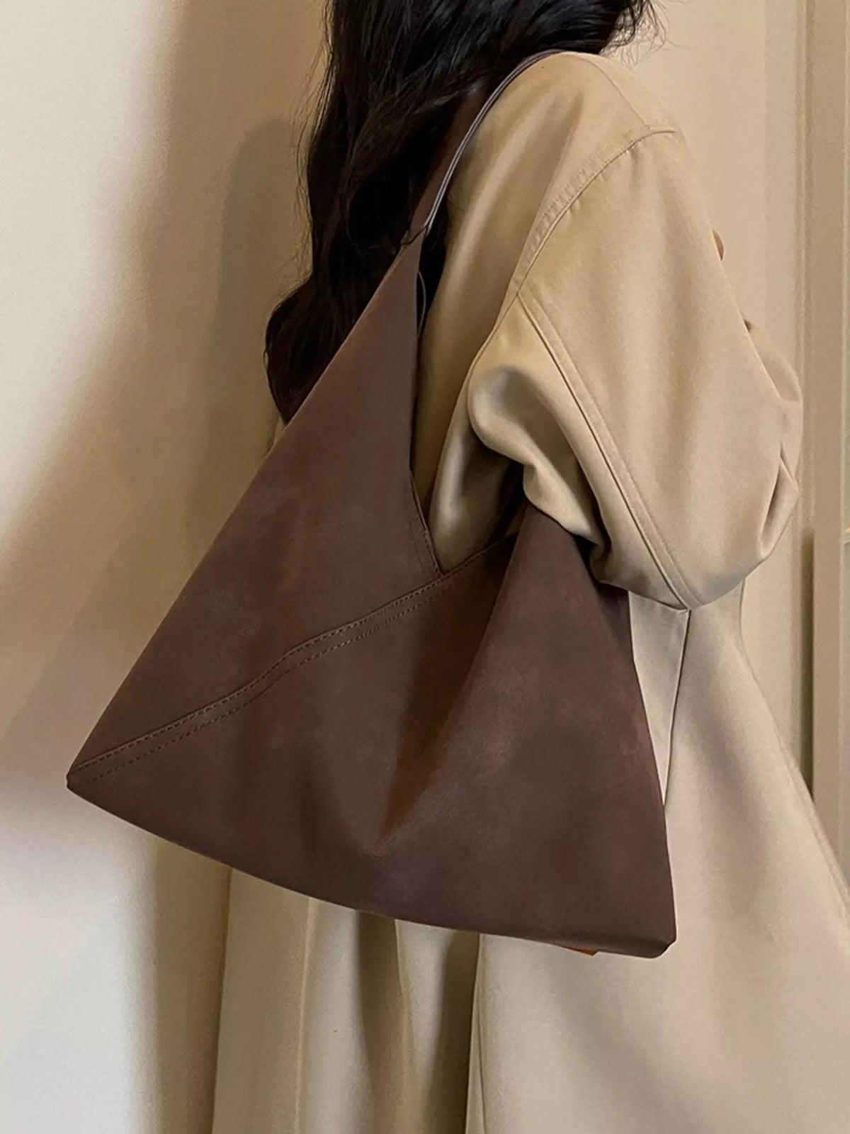 Brown slouchy suede shoulder bag with open top and wide shoulder strap