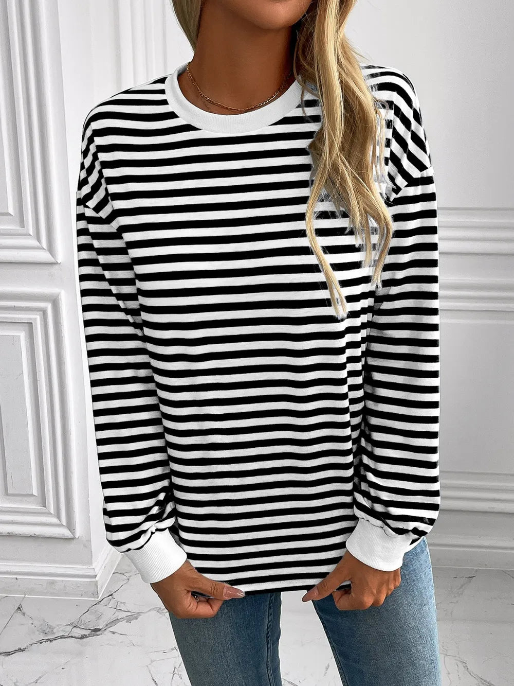 Striped crewneck long-sleeve sweatshirt in black and white, front view