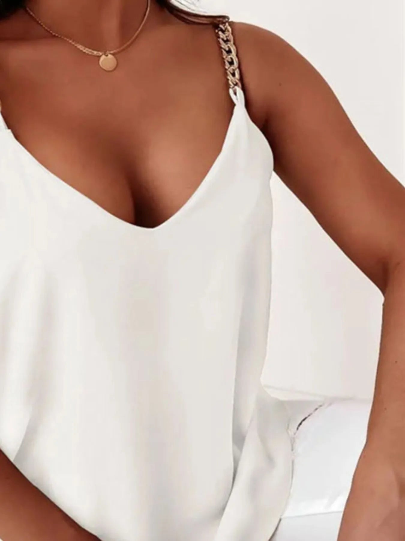 White chain-strap v-neck tank top with deep v neckline and smooth fabric front.
