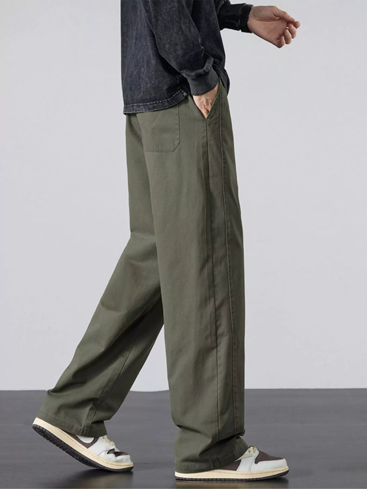 Mens army green wide-leg pants with elastic waistband and white drawstring at front