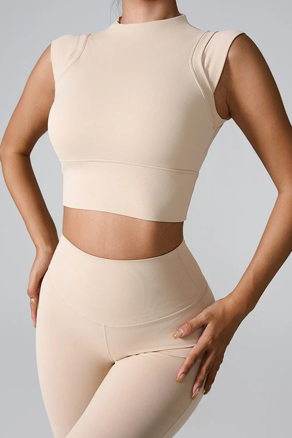 Cream cropped mock neck active tank, sleeveless, fitted.