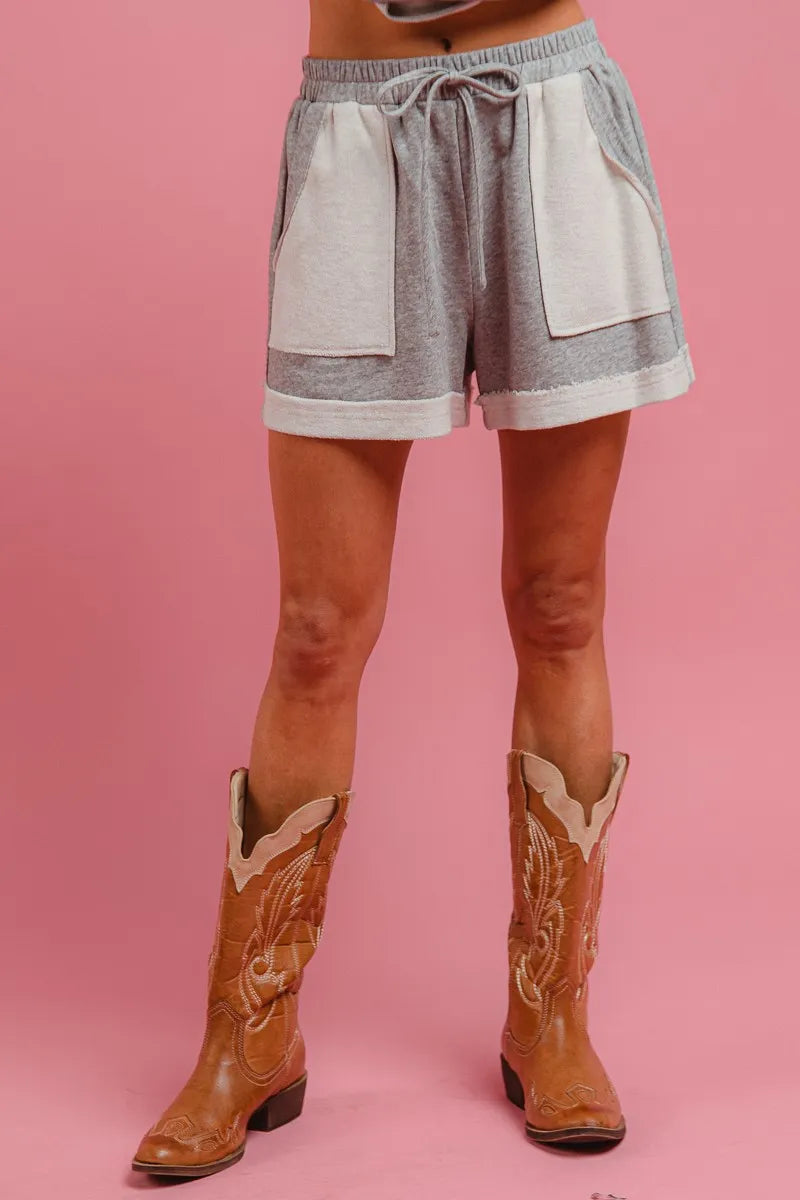 Heather grey French terry knit shorts with drawstring, side pockets, and cuffed hem