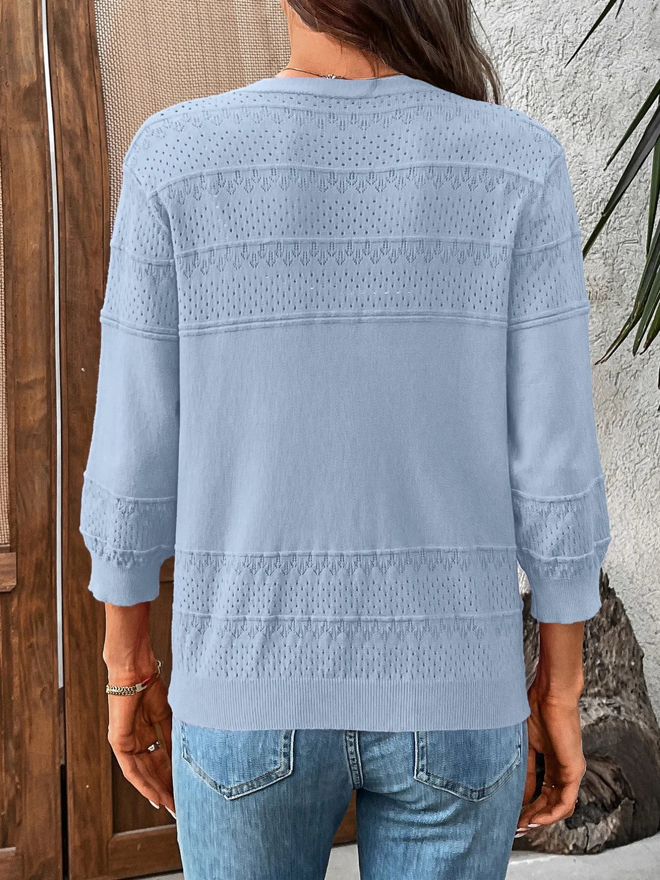Light blue textured button-front cardigan, back view with 3/4 sleeves