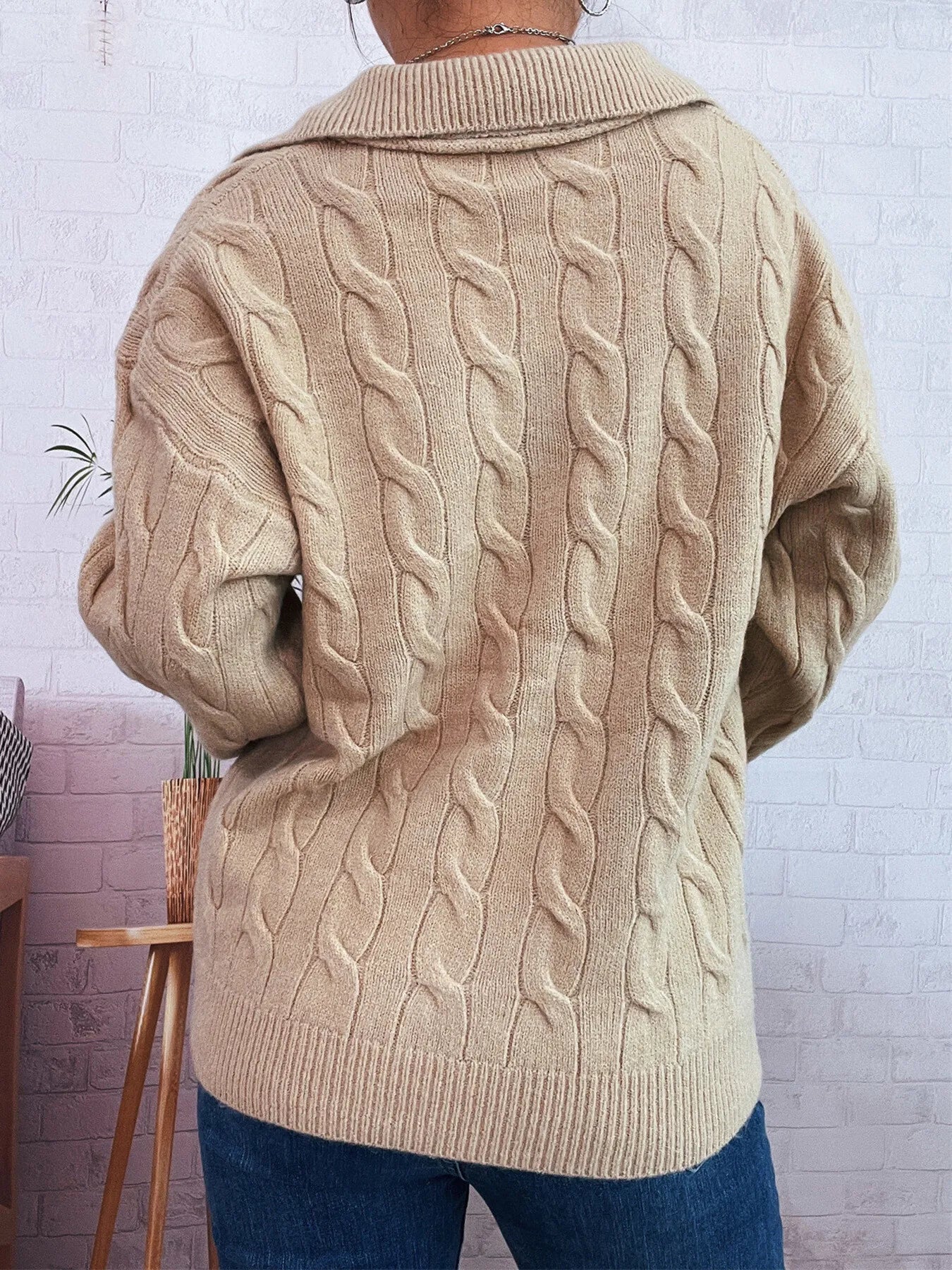 Beige cable-knit sweater with textured cable pattern and ribbed high Johnny collar