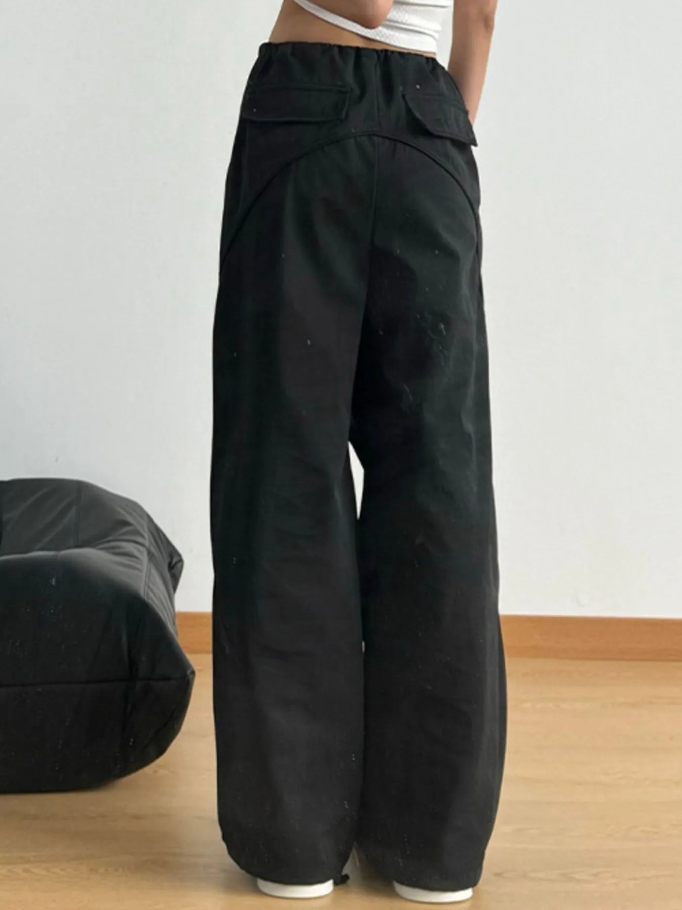 Black wide-leg drawstring pants with elastic waistband and loose, wide legs
