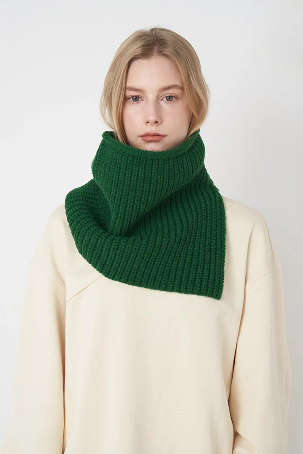 Dark green ribbed knit pullover scarf worn as a folded cowl neck warmer