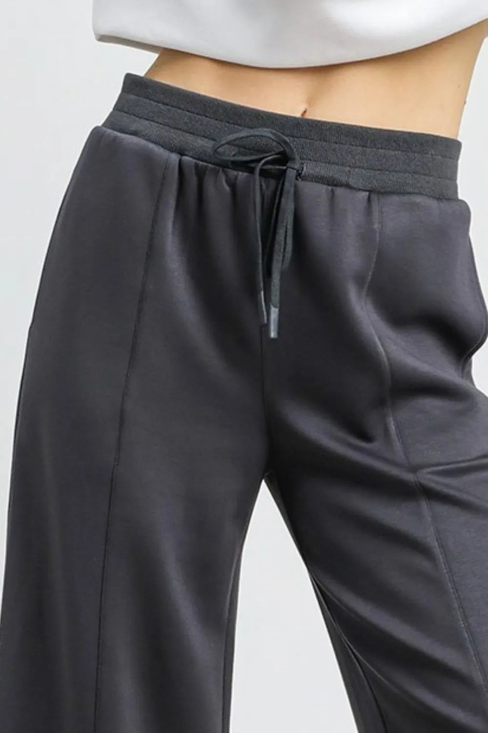 Dark gray wide-leg cropped pants with elastic waistband and front drawstring