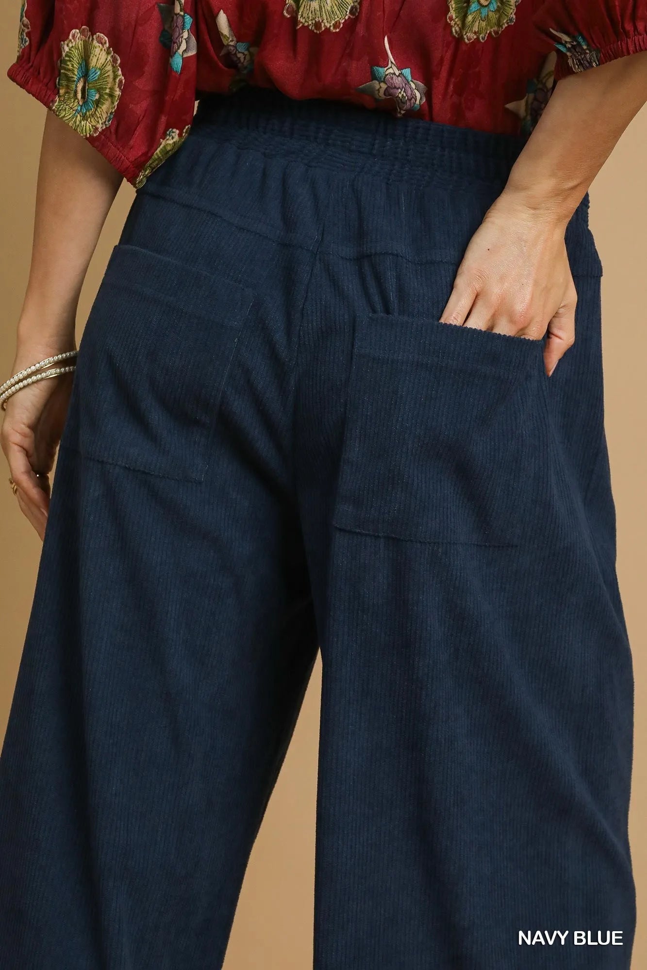 Navy blue corduroy pants with elastic waist and large front patch pockets