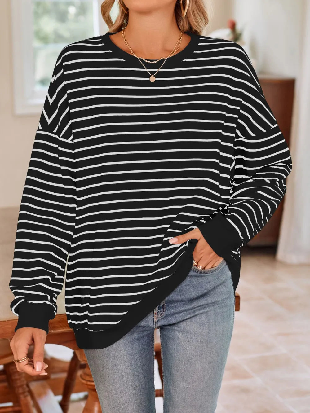 Back view of black striped crew-neck long-sleeve sweatshirt with white lines
