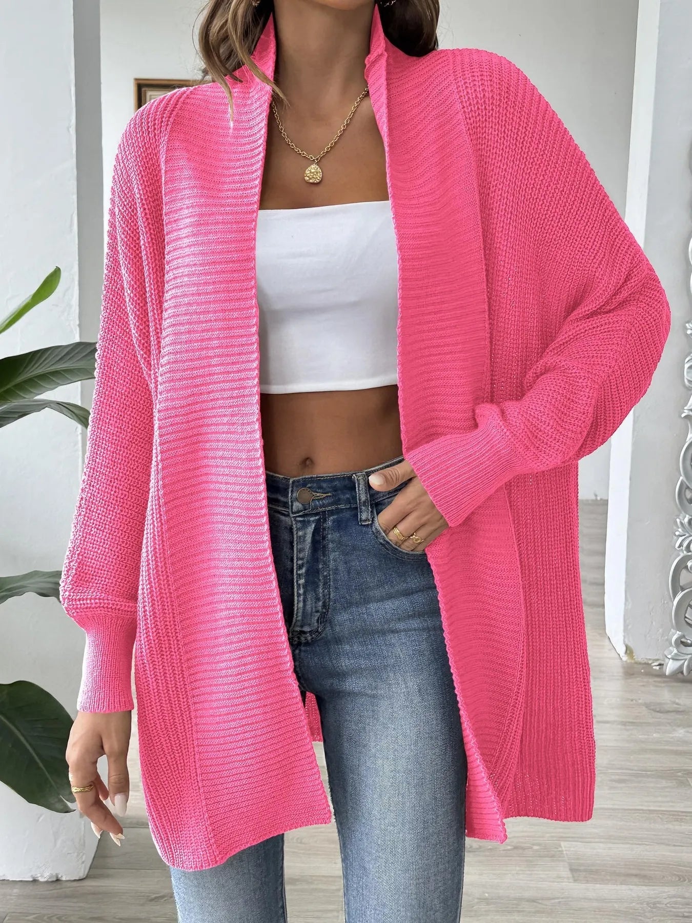 Hot pink oversized knit open-front cardigan with long sleeves and chunky texture