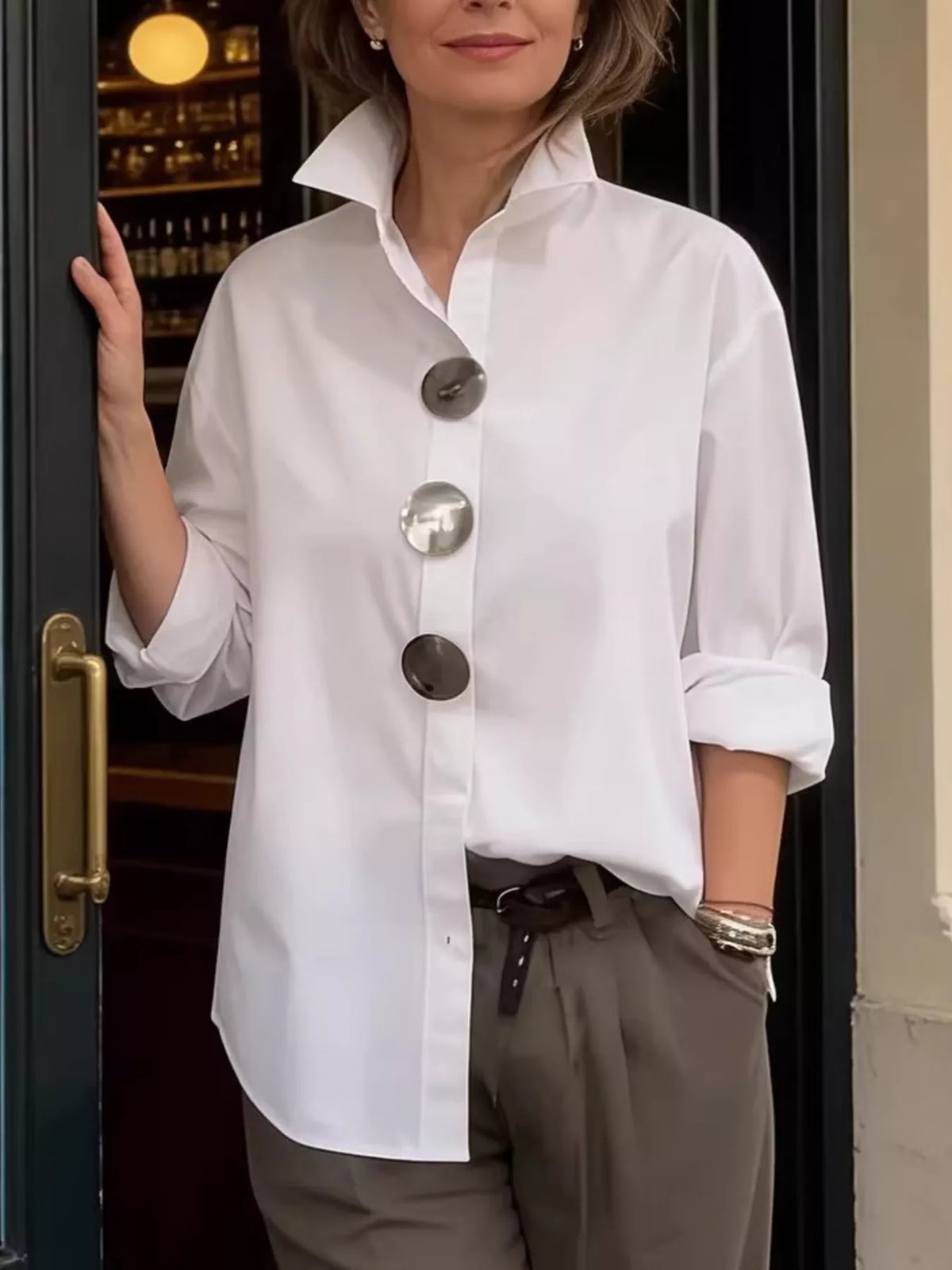 White oversized long-sleeve button shirt with metallic round buttons and point collar