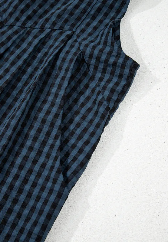 Dark blue plaid overalls fabric close-up