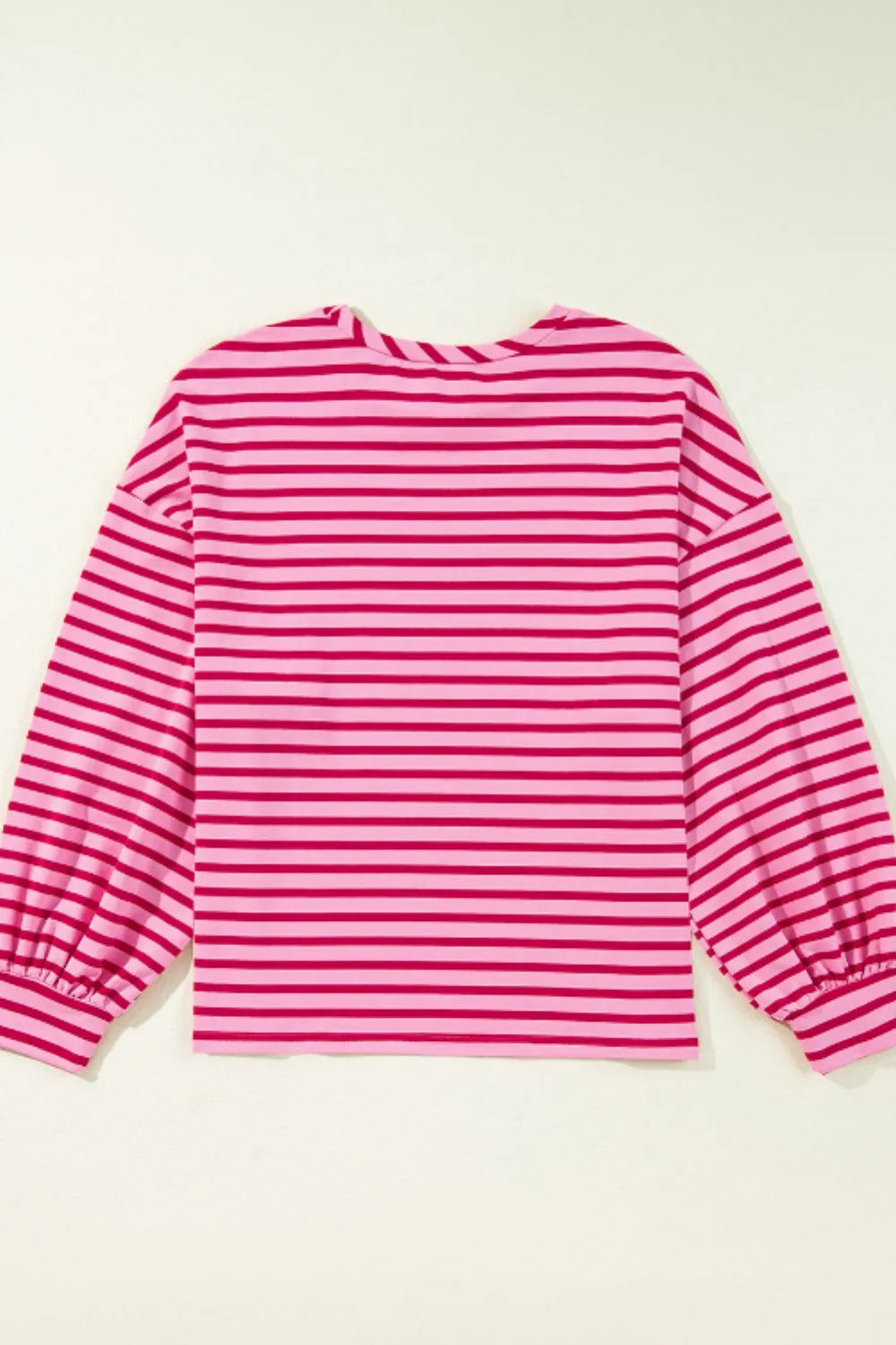 Hot pink striped long-sleeve sweatshirt with round back neckline and gathered hem.