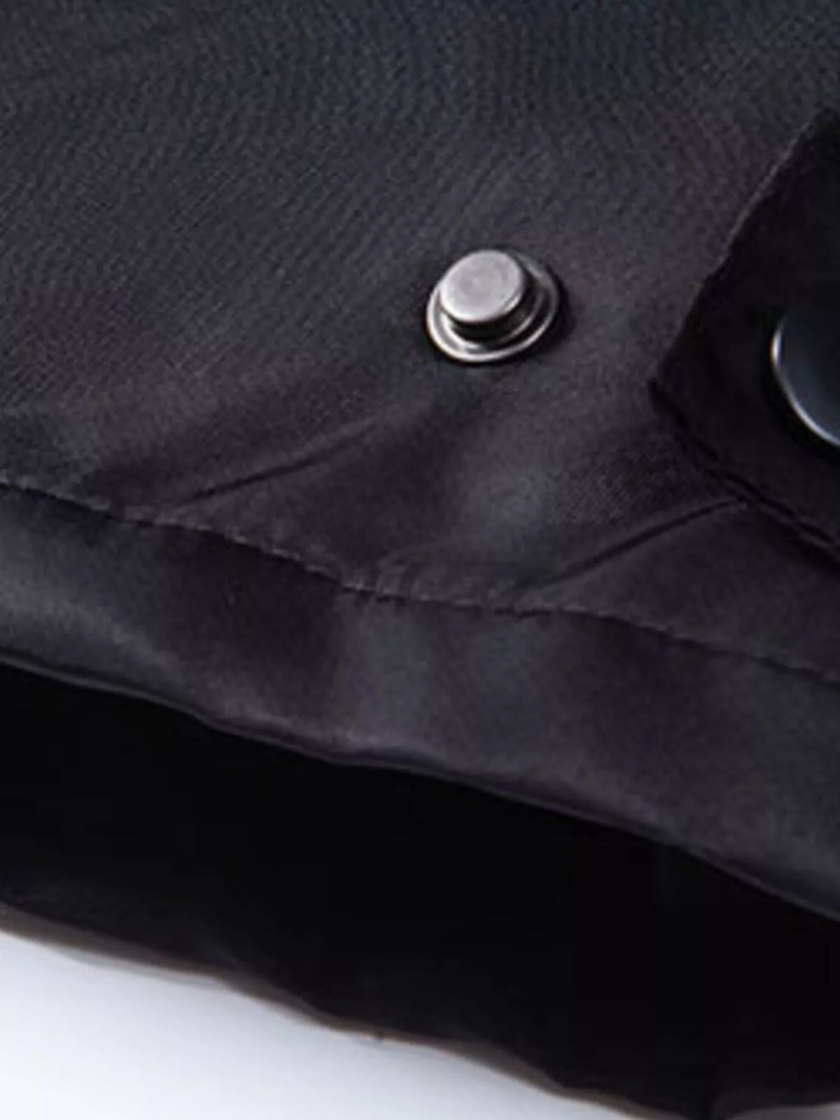 Black waterproof jacket fabric with snap button and stitched seam detail