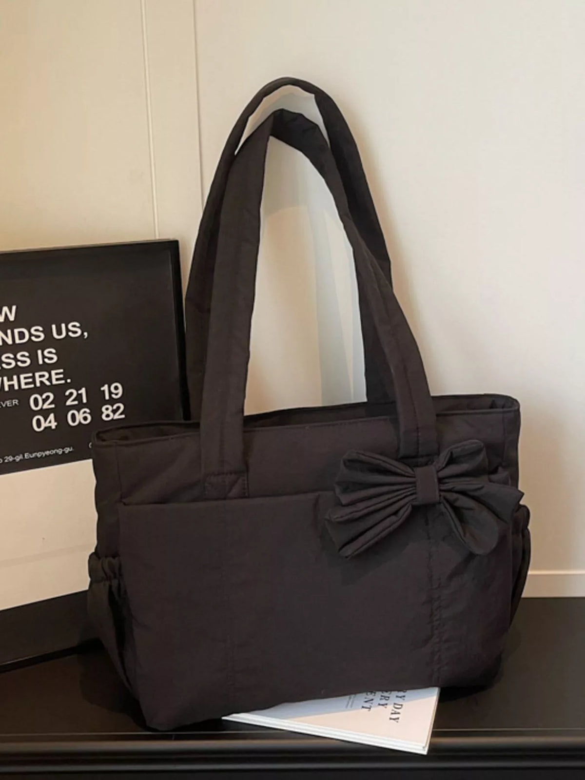 Black medium casual tote bag with ruched front bow and sturdy wide straps