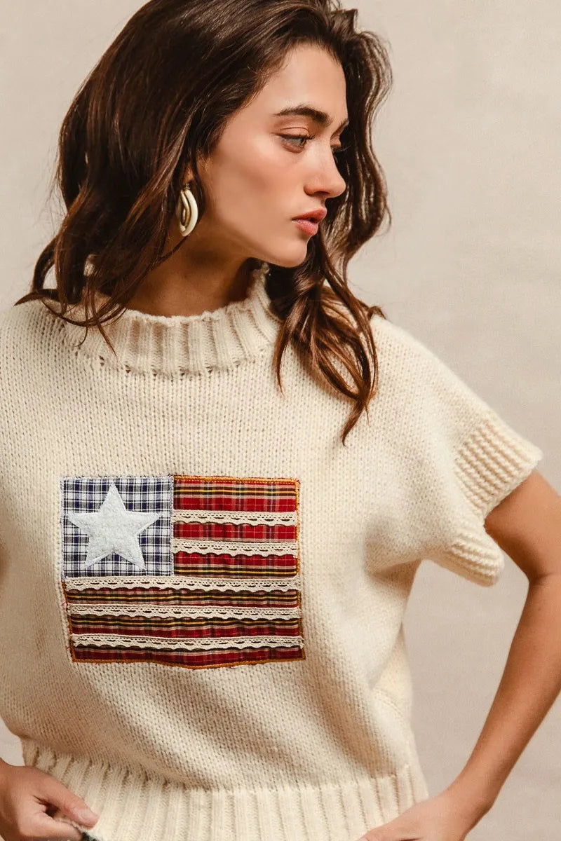 Oatmeal knit sweater with American flag patch, short sleeves, ribbed hem