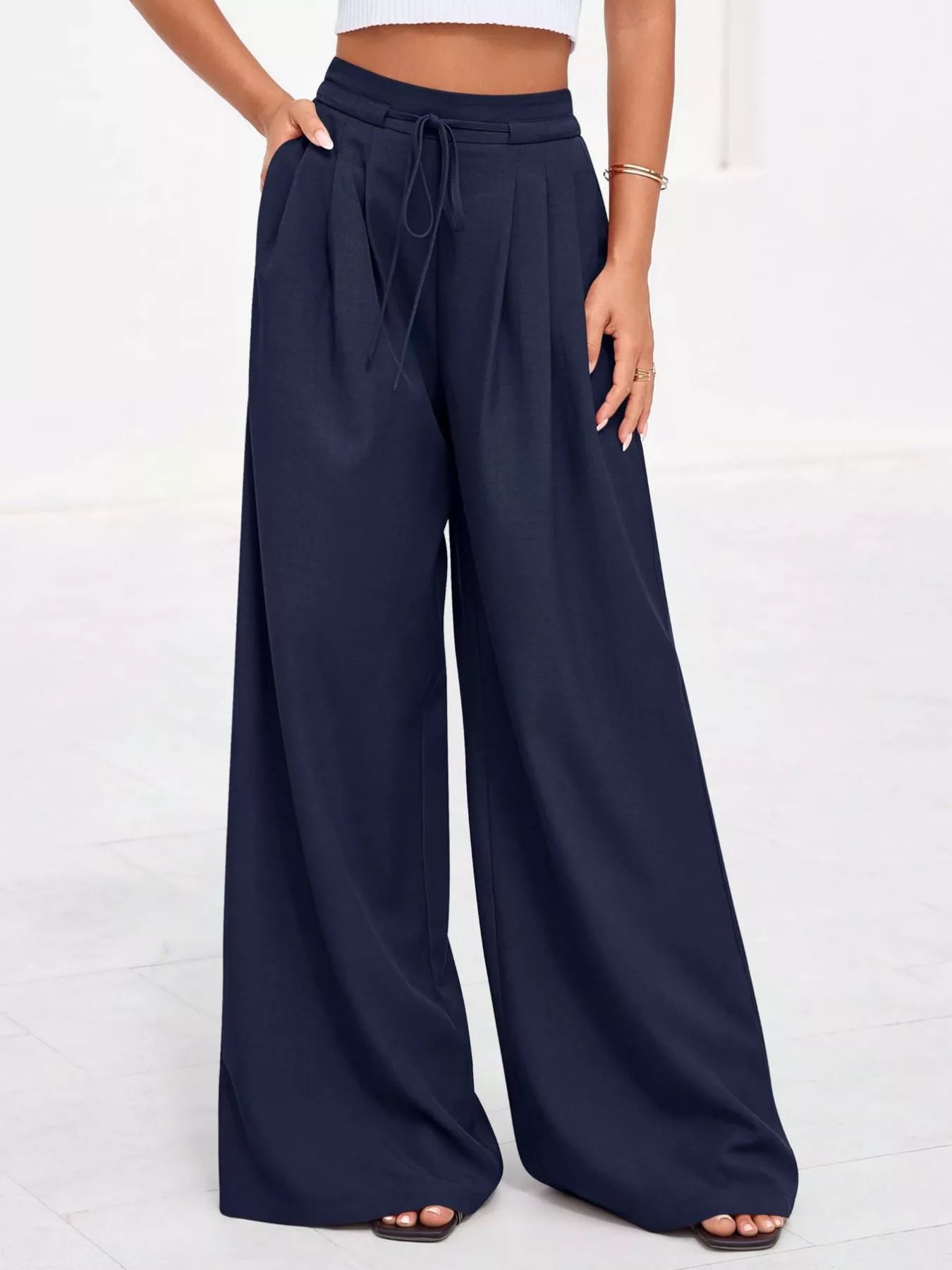 Dark blue high-waisted wide-leg pleated pants with drawstring and elastic waist