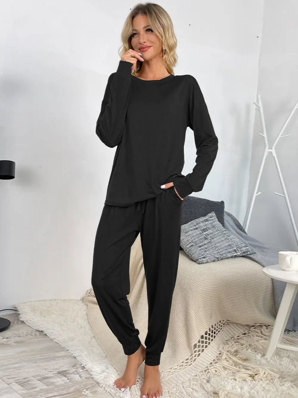 Black lounge set with long-sleeve round-neck top and drawstring jogger pants, front view
